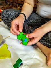 Woman sculpt with plasticine at home