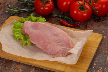 Raw Turkey steak served rosemary