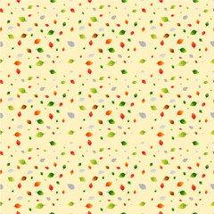seamless pattern of multicolored leaves on a light yellow background