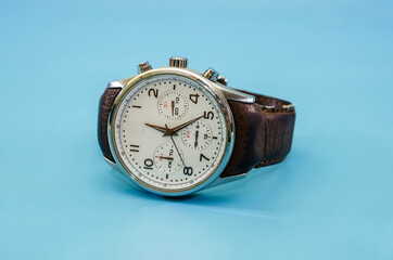 men's wristwatch isolated on a blue background. Close-up.