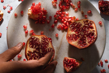 pomegranate seeds on a marble board
