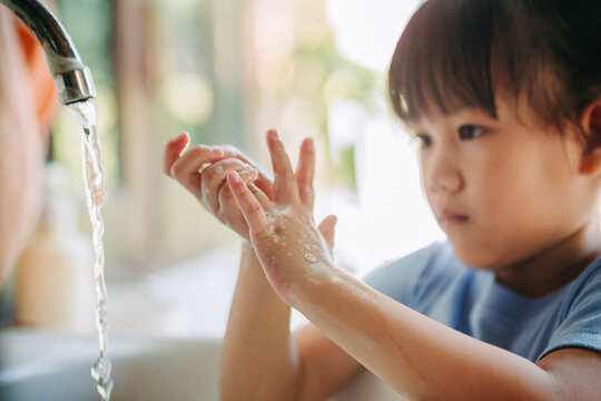 Kids washing hands with liquid soap and water for prevention from covid-19 or coronavirus infection. Clean hands sanitizer protect against virus infection concept.