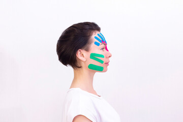 Face taping, close-up of a girls face with cosmetological anti-wrinkle tape. Face aesthetic taping. Non-invasive anti-aging lifting method for reduction of wrinkles