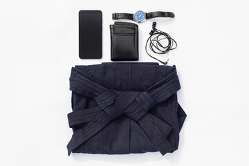 Martial arts. Aikido, Kendo or Iaido Classes Set. Blue hakama pants, phone, earphones and wallet and watch on a white background.