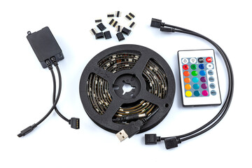 Usb led strip kit. Reel of RGB led strip light with remote control on white background