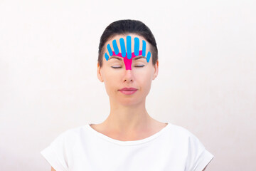 Face taping, close-up of a girls face with cosmetological anti-wrinkle tape. Face aesthetic taping. Non-invasive anti-aging lifting method for reduction of wrinkles
