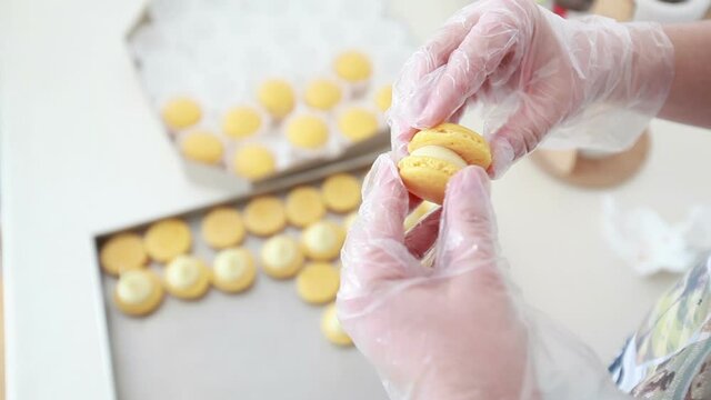 delicious french cake making macarons shells with chocolate cream, small business concept