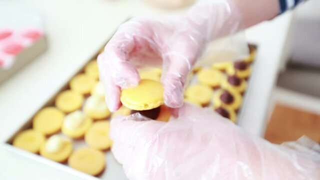 delicious french cake making macarons shells with chocolate cream, small business concept