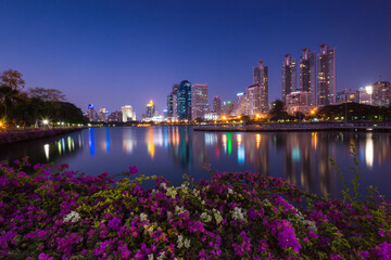 Reflection of public buildings at the public park at dusk, Bangkok, Thailand.