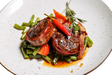 Veal medallions on a white background