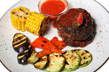 Grilled meat with vegetables on a white background