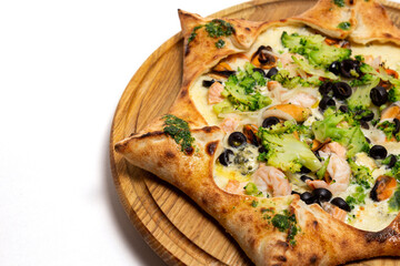 Star shaped pizza with cheese and seafood on a white background