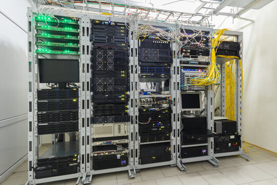 There are several racks with powerful computer equipment in the server room. Computing hardware works in a modern data center. The technical platform of the telecommunication Internet service provider