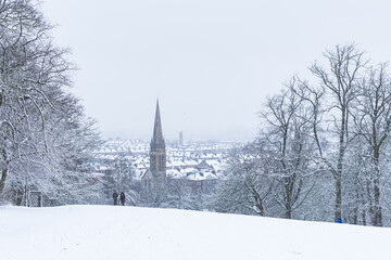A couple walking  through the Glasgow's Queens Park in heavy snow storm in Glasgow.