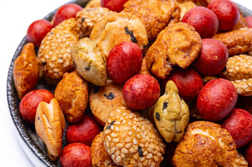 Tasty asian vegetarian appetizer, crunchy rice en peanuts snacks from Japan close up on white backgound