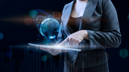 Businesswoman holding tablet computer and global worlg head up display. International...