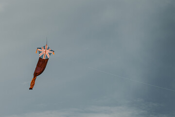 Kite fly against the dark moody sky