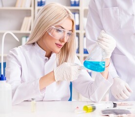 Young woman chemist working in clinic lab