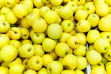 Yellow apples for sale in supermarket. top view organic fruit on the shelves of the hypermarket