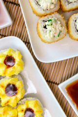 tempura Maki sushi rolls with cream cheese, on a white plate close-up. Deep-fried vertical photo. for two persons