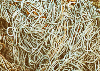 Background of tangled fishing nets, toned.