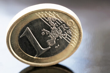 One euro coin stands on edge