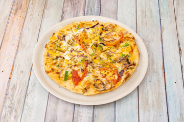 Vegetable pizza on wooden table