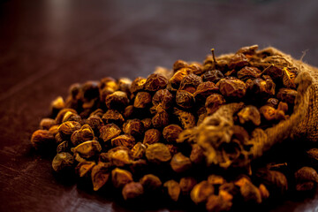 Classic shot of reetha or aritha or soapnut in a gunny bag on the brown surface.