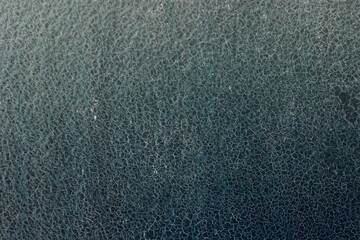 Beautiful vintage blue background with old blue paint with a rough surface, streaks and uneven texture of blue paint on an old rough surface