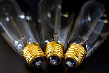 close up bulbs and yellow bulb bases, electrical foot contact, idea bulb concept wallpaper. golden color