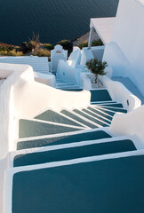 Traditional narrow stair street leading to the sea. Oia village, in Santorini Island, Greece. Landscape Greek islands