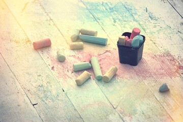 Colored chalk on the wooden table.