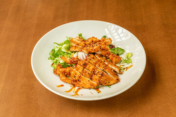 Katsu salad with chicken on white plate