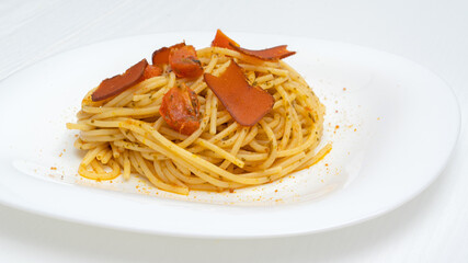 spaghetti with mullet fish and tomato on the plate