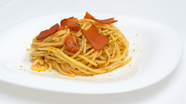 spaghetti with mullet fish and tomato on the plate