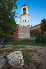 Fototapeta na wymiar The Bell tower of the cathedral in Vyborg after reconstruction and a memorial stone is a tourist place and a landmark of the old city.