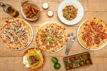Fototapeta na wymiar Image of table full of Italian pizzas