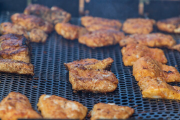 Whole and portioned fresh grilled fish for sale on the market.