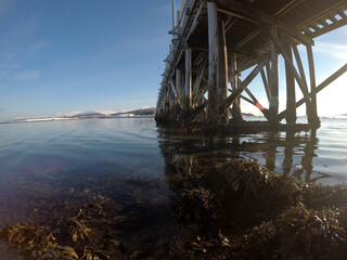 old car bridge over blue fjord as the winter sun is rising