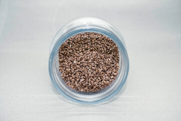 Buckwheat groats in a glass jar on a light background close-up. Healthy diet vegan food.  