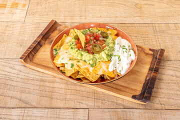 Delicious plate of Mexican nachos with guacamole