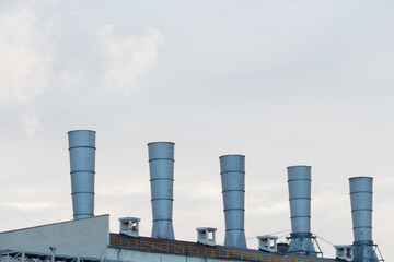 Roof of a factory with conical pipes, copy space.