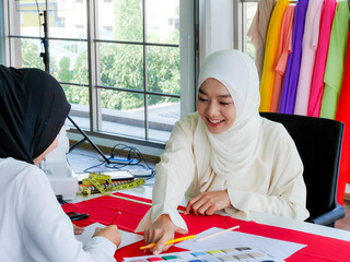 ชื่อผลงาน: female muslim fashion designers wearing HIJAB working on dress stylist...