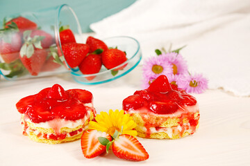 Homemade tasty mini Strawberry and Yogurt cream sponge cake. two small Delicate and delicious biscuit cakes with cream and strawberries. Beautiful birthday cake on table