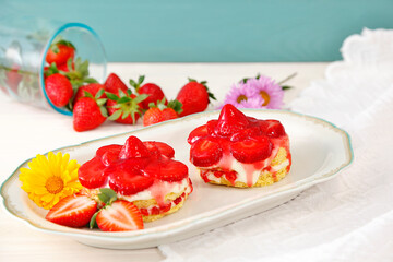 Homemade tasty mini Strawberry and Yogurt cream sponge cake. two small Delicate and delicious biscuit cakes with cream and strawberries. Beautiful birthday cake on table