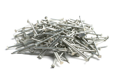 A pile of metal nails on a white background. An isolated object. Concept for construction and repair design.