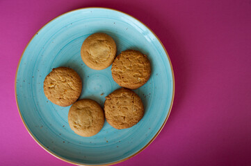 fresh sweet pastries. delicious shortbread cookies on a blue plate on a pink background