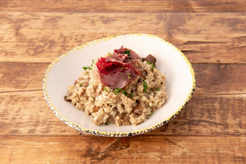 Italian risotto dish on wooden table