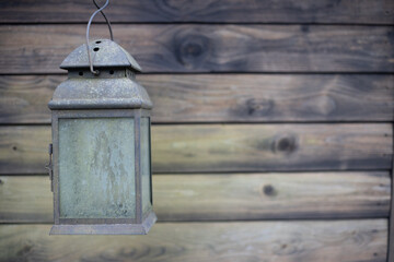 old lantern on wooden wall