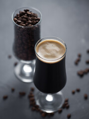 Craft coffee stout beer in a glass and roasted coffee beans